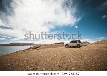 Driving off road car on the high altitude mountains 