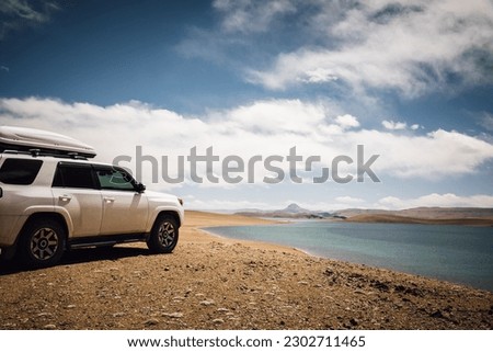 Driving off road car on the high altitude mountains