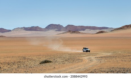 Driving offroad at gravel road, a 4x4 track in rocky desert landscape of Messum Crater in Damaraland, Namibia, Africa.