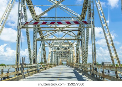 Driving On Chef Menteur Highway With Old Bridge In East Area Of New Orleans Crossing The Bay