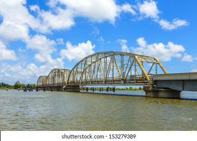 Driving On Chef Menteur Highway With Old Bridge In East Area Of New Orleans Crossing The Bay