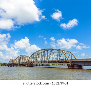 Driving On Chef Menteur Highway With Old Bridge In East Area Of New Orleans Crossing The Bay