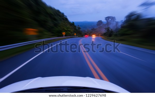 driving on country road and sharp curved on\
mountain and front of car at\
night