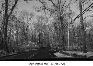 driving on county road on the first day of spring with snow on the ground, black and white