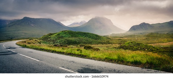 Driving On A Road Towards The Sunset Among Hills, Northern Scotland, UK