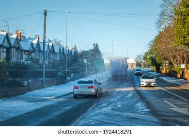 Driving On Winter Snow Road In Town In England Uk During Covid Lockdown.