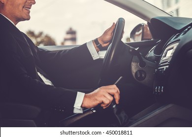 Driving With Pleasure. Close-up Of Cheerful Mature Man In Formalwear Driving Car And Smiling