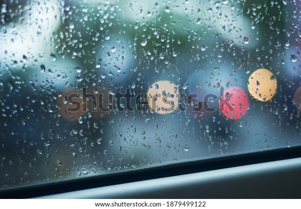 driving rain\
raindrops car window light\
bokeh