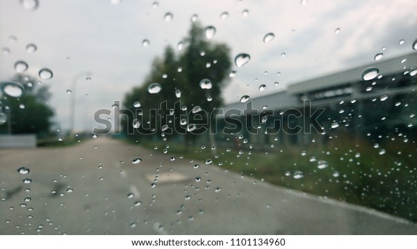 Driving
in rain. Rainy weather through the car window.
