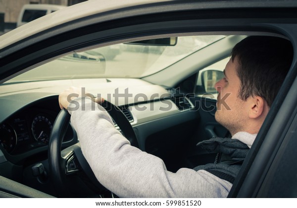 Driving safety. A
young man driving a
car.