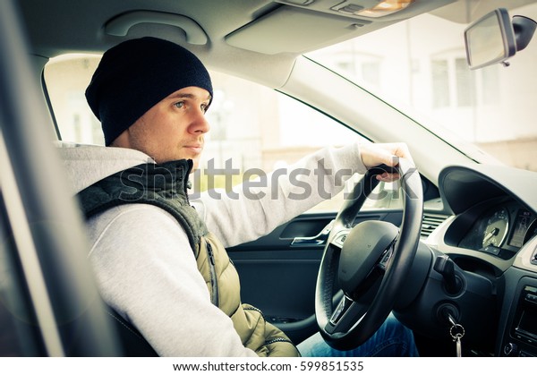 Driving safety. A\
young man driving a\
car.