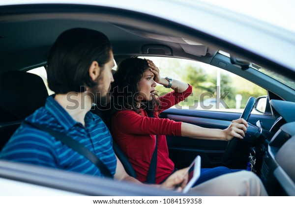 Driving school. Stressed and disappointed young\
woman failed on driving\
test.