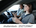 Driving school. Student passing driving test with examiner in car