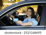 Driving school. Woman with driving license in car