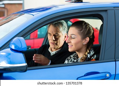 Driving School - Young woman steer a car, maybe she has a driving test perhaps she exercises the parking