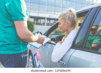 Driving school. Young woman or driving student passing driving license exam outdoors. Copy space. Lens flare