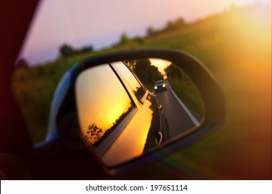 Driving At Sunset - Peek Into A Rear View Mirror