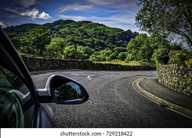 Driving Through A Country Road In The Lake District In England, UK