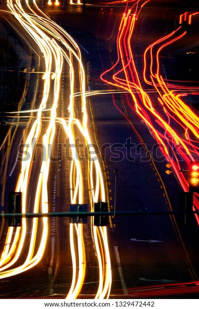 Driving in traffic at night dark with lights\
streak on road or\
highway