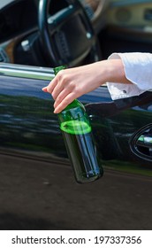 Driving Under The Influence. Female Hand With Bottle Of Beer.