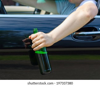 Driving Under The Influence. Male Hand With Bottle Of Beer.