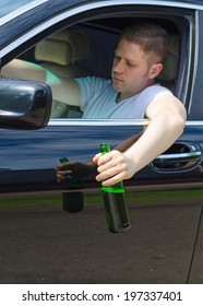 Driving Under The Influence. Male Hand With Bottle Of Beer.