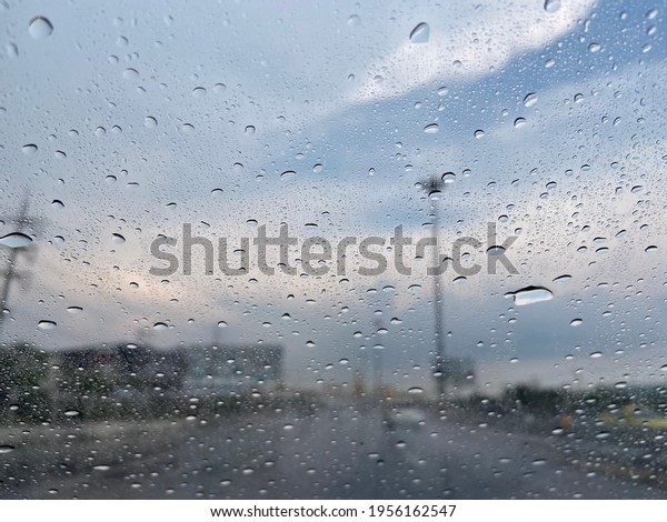 Driving when\
raining under blue sky on highway, rarely see car on the road\
because of rain drop pouring on glass surface is bad vision\
environment for transport, point of\
view