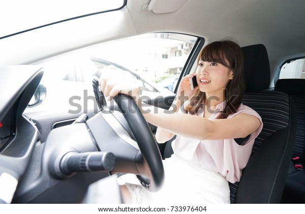Driving woman using
smartphone