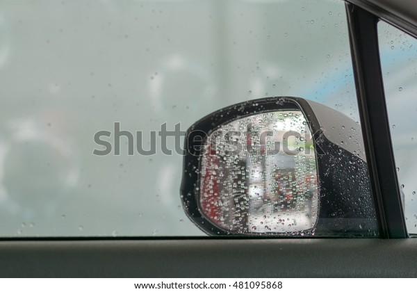 Drizzle at the car\
window and wing mirror.