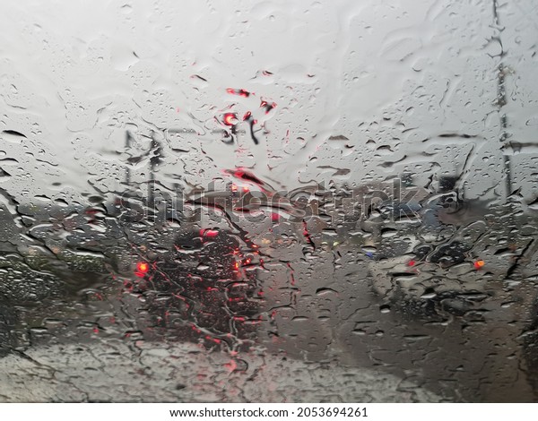 Drizzle in front of the windshield of the car\
during the rainy season