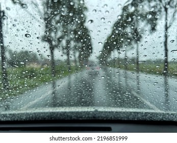 Drizzle On The Windsheild, Inside Car When Rainning, Road View Through Car Window With Rain Drops, Selective Focus.