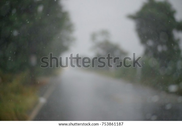 Drizzle on the windshield, Inside\
car when rainning, Road view through car window with rain\
drops.