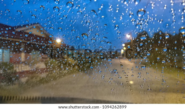 Drizzle\
on the windshield in the morning with blue sky.\
