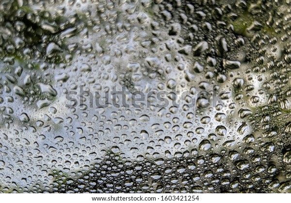 Drizzle on the windshield. Water drops on the\
window, Abstract\
background.
