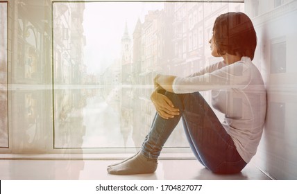 Dromophobia. Close up photo of a young woman who is looking through the window and crying, triggered by negative emotions. Double exposure.