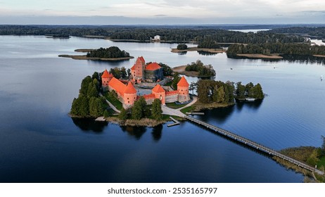 Drone aerial footage of Trakai Castle in the evening. Lakes, forests and islands around. Aerial drone shot of red brick medieval castle on island in Trakai, Vilnius region, Lithuania.  - Powered by Shutterstock