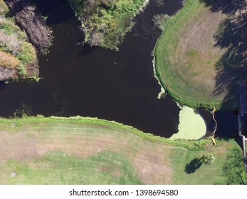 Drone Aerial Image Of An Algae Bloom In A Storm Water Retention Pond In A Suburban Neighborhood Park In Florida