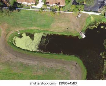 Drone Aerial Image Of An Algae Bloom In A Storm Water Retention Pond In A Suburban Neighborhood Park In Florida