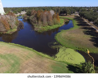 Drone Aerial Image Of An Algae Bloom In A Storm Water Retention Pond In A Suburban Neighborhood Park In Florida