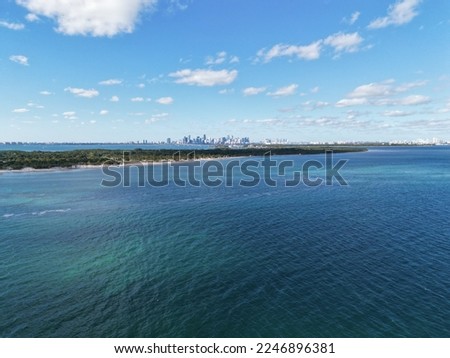 Drone aerial over Key Biscayne with a view of downtown Miami skyline in distance