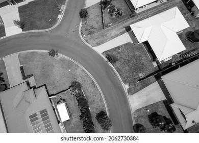 Drone Aerial Over Rooftops Of Suburban Homes And Street