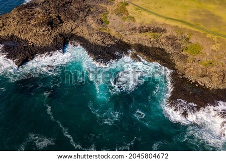 Drone aerial photograph of the ocean crashing against rocks in Kiama on the south coast of New South Wales in Australia