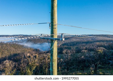 Drone Aerial Photograph Of A Telephone Pole And Wires In A Forest Affected By Bushfires