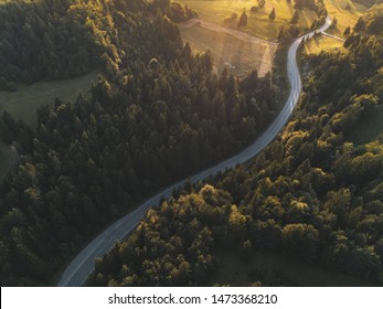 Drone Aerial Shot Of Beautiful Winding Road With Sunset Summer Colors