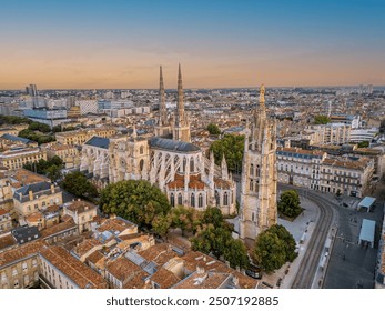 The drone aerial view of Bordeaux Cathedral and Pey Berland Tower at sunrise, Bordeaux, France.