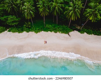Drone aerial view at couple on the beach at Freedom beach in Phuket Thailand during vacation, top view at tropical beach with people on the beach - Powered by Shutterstock
