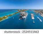 The drone aerial view of cruise ships in the clear blue Caribbean ocean docked in the port of Nassau, Bahamas.