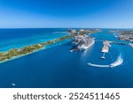 The drone aerial view of cruise ships in the clear blue Caribbean ocean docked in the port of Nassau, Bahamas.