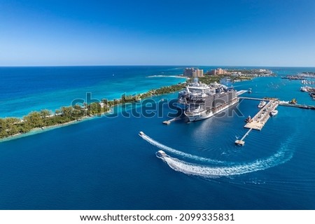 The drone aerial view of cruise ships in the clear blue Caribbean ocean docked in the port of Nassau, Bahamas.