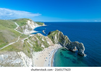 The drone aerial view of Durdle Door and beach. Durdle Door is a natural limestone arch on the Jurassic Coast near Lulworth in Dorset, England.